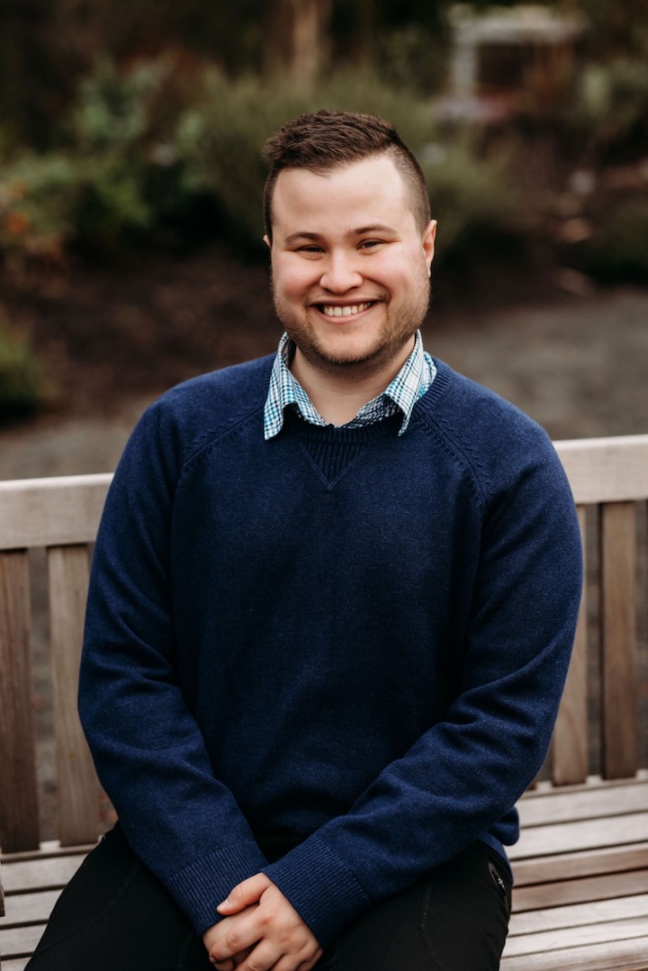 Photo of Andrew sitting on a bench